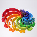 The Grimm's Large Rainbow surrounded by other Grimm's rainbow coloured wooden toys.