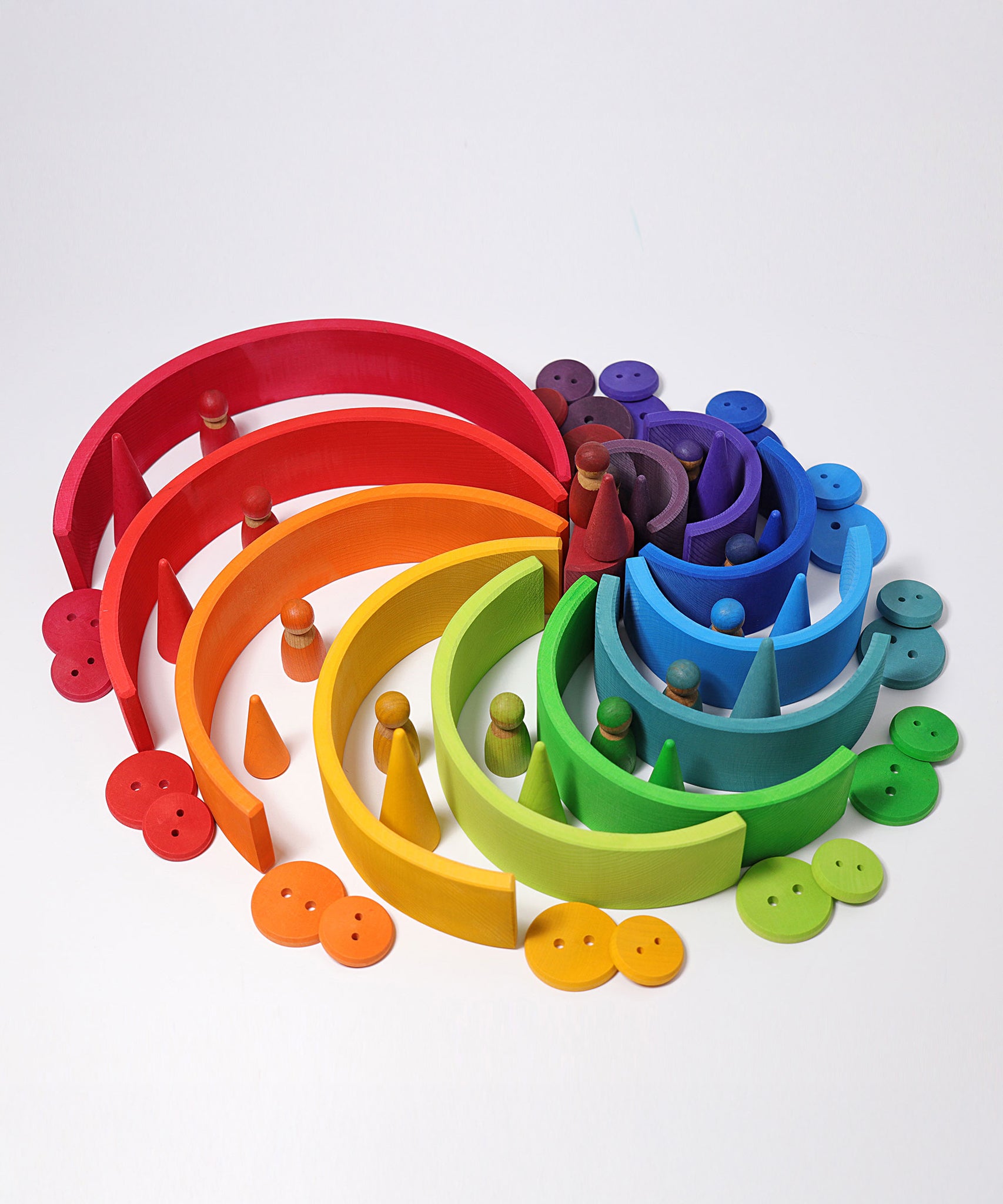 The Grimm's Large Rainbow surrounded by other Grimm's rainbow coloured wooden toys.