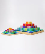 The large Grimm's rainbow coloured Large Stepped Pyramid wooden toy building block set pictured next to a small version. These Grimm's toys are part of a wide range of wooden toys available here at Babipur.