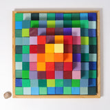 An overhead view of the Grimm's rainbow coloured Large Stepped Pyramid wooden toy building block set in the wooden storage tray. These Grimm's toys are part of a wide range of wooden toys available here at Babipur.