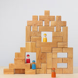 The Grimm's Natural Wooden Stairway Building Set built up with Grimm's friends placed on the structure.