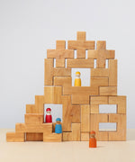 The Grimm's Natural Wooden Stairway Building Set built up with Grimm's friends placed on the structure.