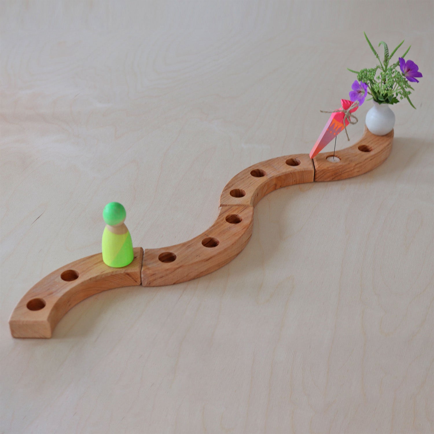 Grimm's Sweet Cone Decorative Figure - Neon Pink. The cone sits in a Grimm's celebration ring.