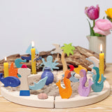 A ocean themed setup featuring different wooden Grimms figures including the mermaids slotted on a celebration ring