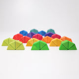 The triangluar shaped blocks from the Grimm's Octagon Puzzles shown stacked together in groups of 4 to create semi circles.