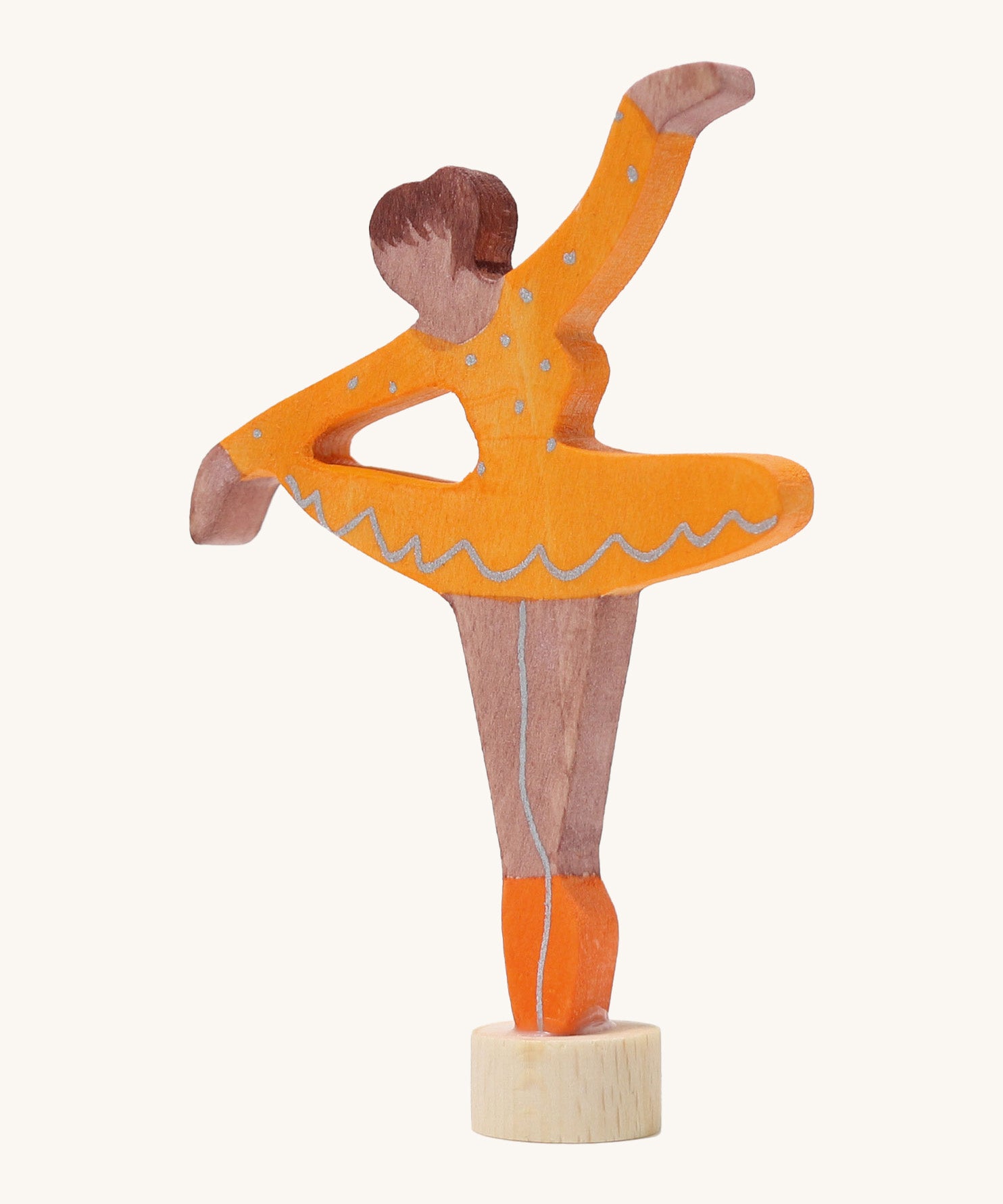 A Grimms wooden ballerina decorative figure in orange. Features a small base on the bottom to slot into the celebration ring.