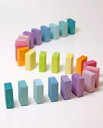 Grimms Wooden Pastel Duo Blocks lined up in an S shape line like dominoes