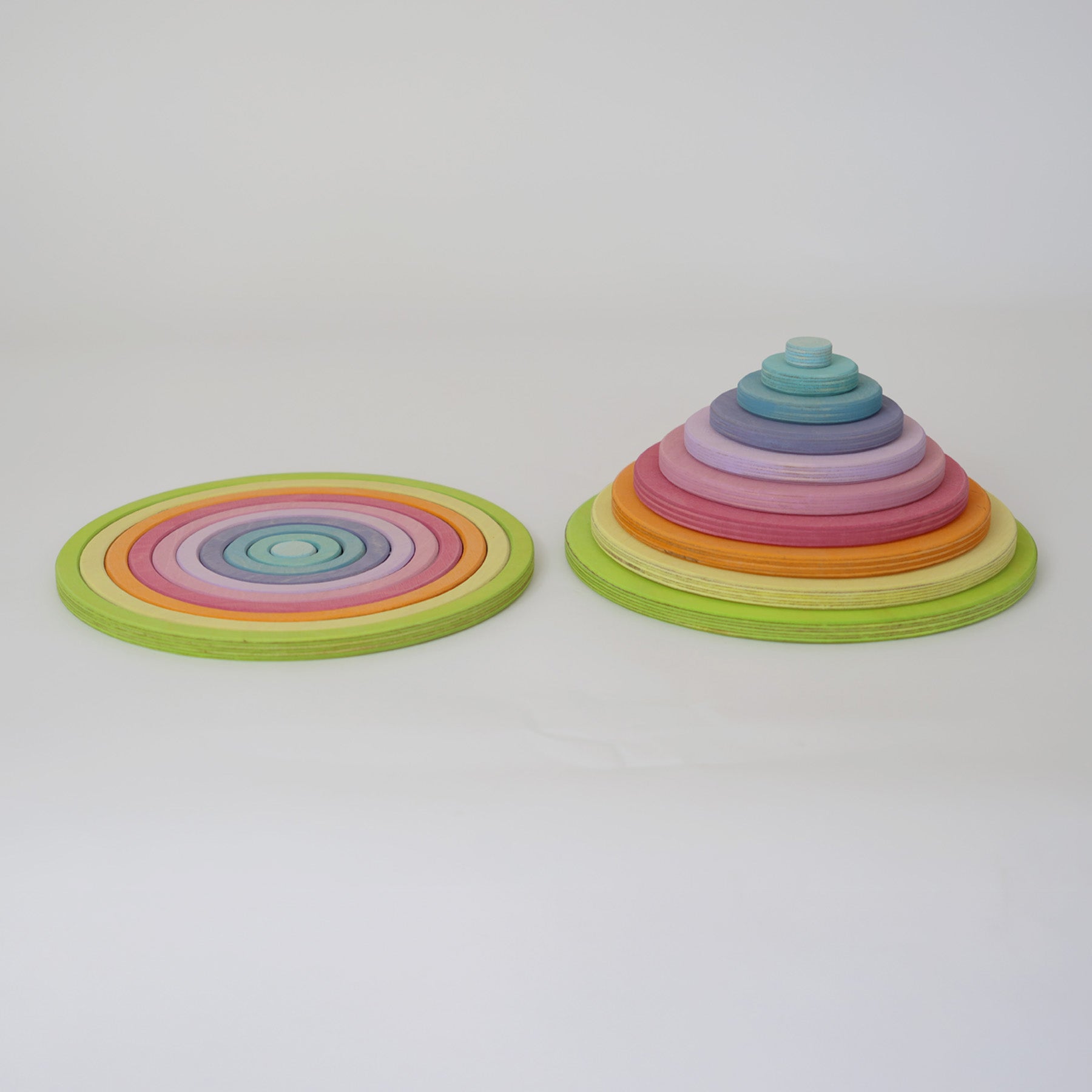 Full Grimm’s concentric circle and ring set laid out by size and colour, ideal for sensory play, stacking, and sorting.