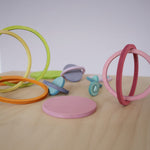 Creative builds using Grimm's concentric rings balanced together, ideal for imaginative open-ended play and motor skill development.