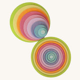 Full Grimm’s concentric wooden circle and ring set laid out by size and colour, ideal for sensory play, stacking, and sorting.