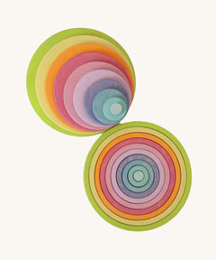 Full Grimm’s concentric wooden circle and ring set laid out by size and colour, ideal for sensory play, stacking, and sorting.