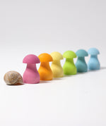 Grimm's Pastel Mushrooms Sorting Game shown all lined up next to a snail shell.
