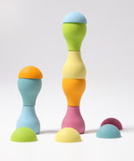 Grimm's Pastel Mushrooms Sorting Game shown with the pieces stacked on top of each other to create little towers.