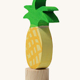 A side view of the Grimms pineapple frog wooden decorative figure showing the thickness of the figure