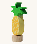 A side view of the Grimms pineapple frog wooden decorative figure showing the thickness of the figure