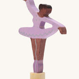 A Grimms wooden ballerina decorative figure in purple. Features a small base on the bottom to slot into the celebration ring.
