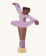 A Grimms wooden ballerina decorative figure in purple. Features a small base on the bottom to slot into the celebration ring.