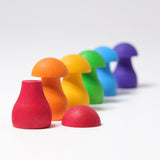 The mushrooms from the Grimm's Rainbow Mushrooms Sorting Game all lined up next to each other.