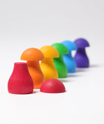 The mushrooms from the Grimm's Rainbow Mushrooms Sorting Game all lined up next to each other.