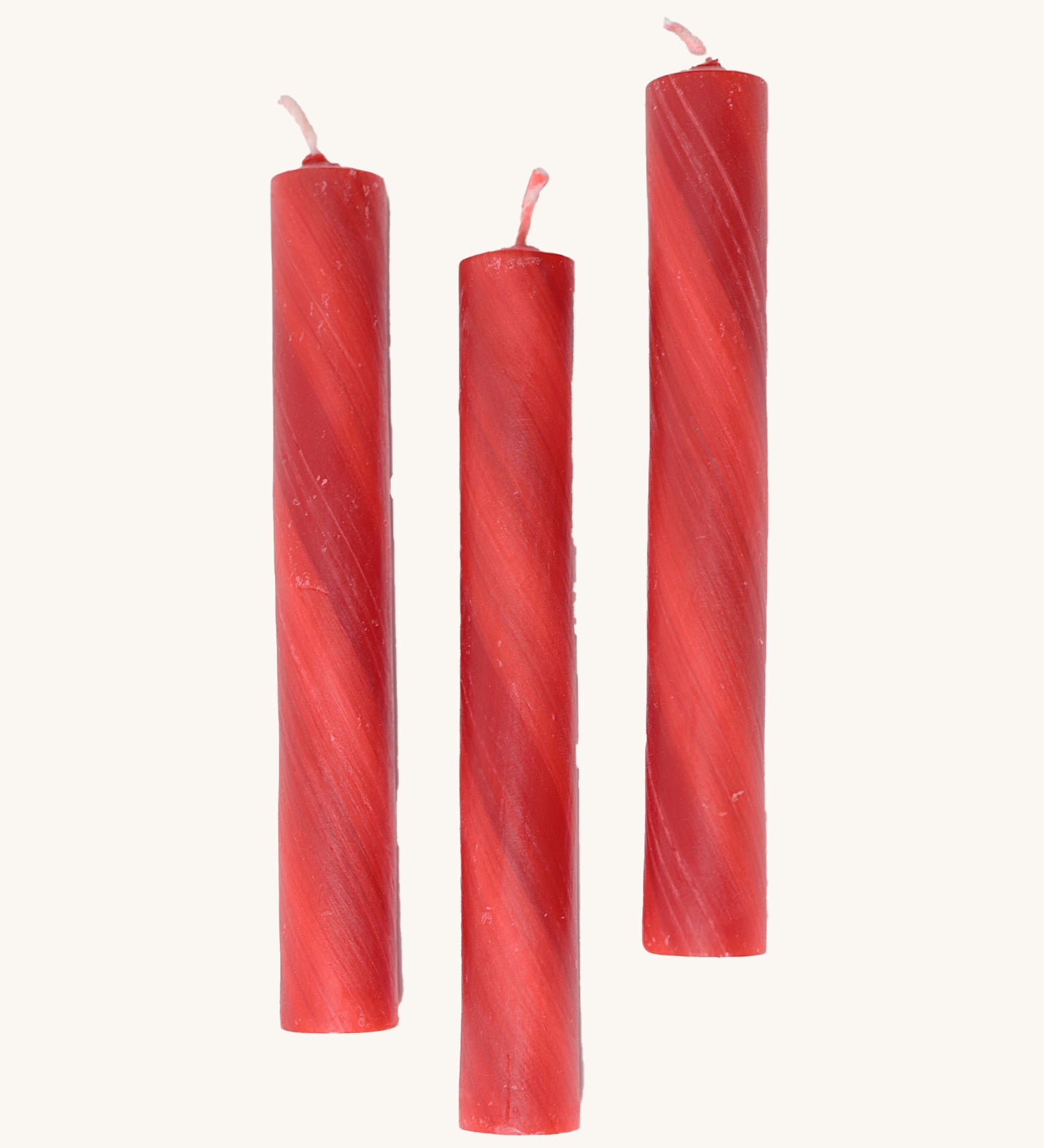 A set of 3 Grimms red marbled candles made from beeswax