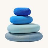 A set of 4 Grimm's wooden pebbles in a blue river colourway.
