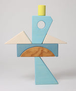 The blocks from the Grimm's blue sail boat building set stacked up.  These Grimm's wooden block sets are part of a wide range of wooden toys available here at Babipur.