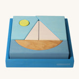 Grimm's Building Set Blue. A set of wooden blocks that form a sailing boat when placed in the blue coloured storage tray. These Grimm's wooden block sets are part of a wide range of wooden toys available here at Babipur.