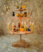 A Grimm's Seasonal Festivity Stand decorated with Autumn and Halloween themed items.
