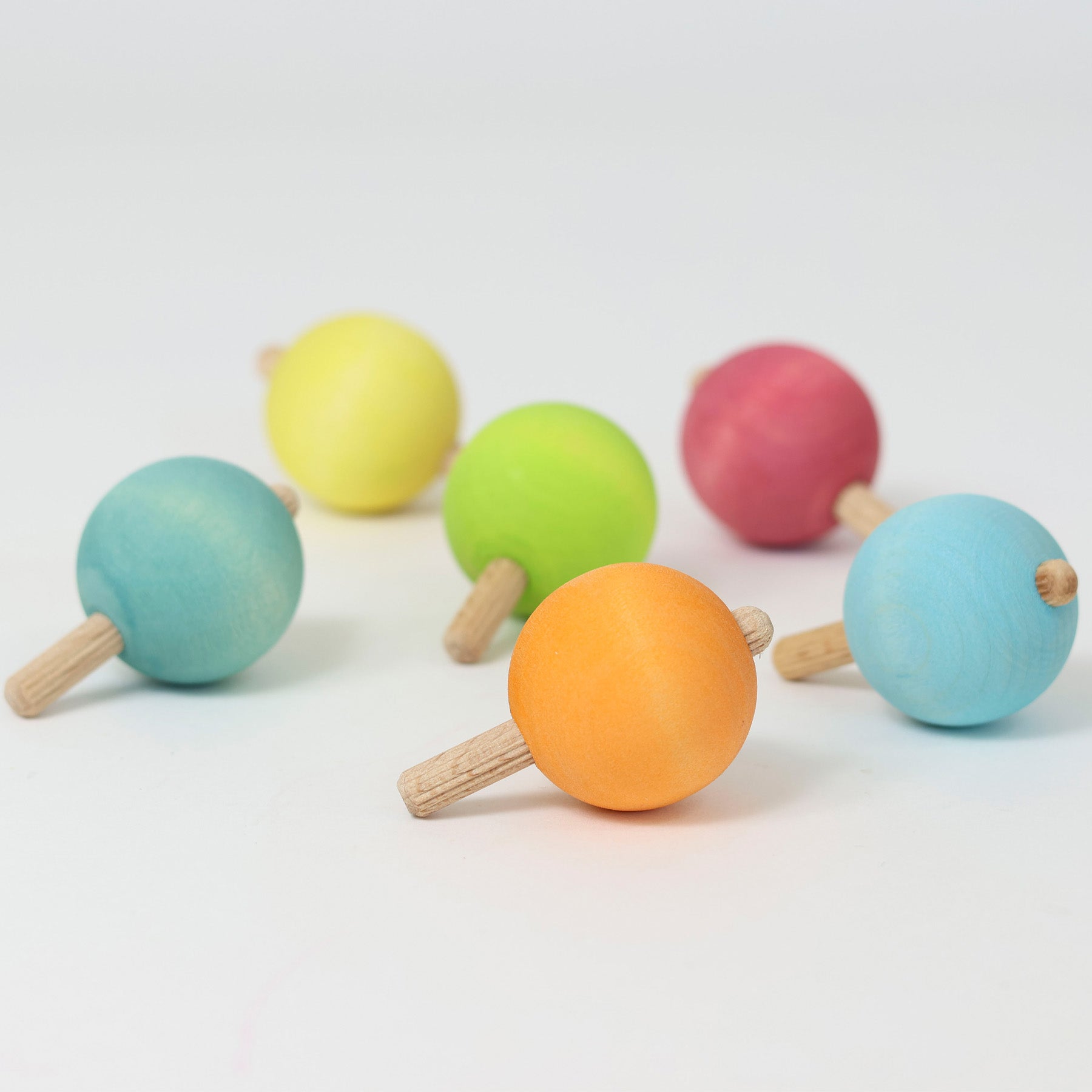 The six pastel rainbow traditional wooden spinning tops from Grimm's