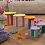 The Grimm's pastel wooden concentric circles, balanced on wooden building blocks to create a staircase, with Grimm's spinning tops spinning on them.