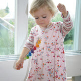A toddler playing with the Grimms spirelli available at Babipur showing the coloured disks threading through the winding wire