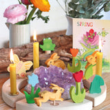 A spring themed display showing the different wooden Grimms decorative figure and candles on the decorative ring