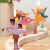 A cosy display showing the different coloured ballerina Grimms wooden decorative figures slotted in the the celebration ring