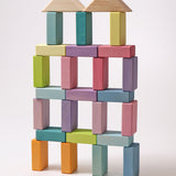 A large building has been made using the Grimms Wooden Pastel Duo Blocks. The roof is made from the natural blocks