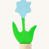 Grimms wooden blue flower decorative figure with green stem and leaves. Features a small base stand on the bottom to slot in the celebration ring