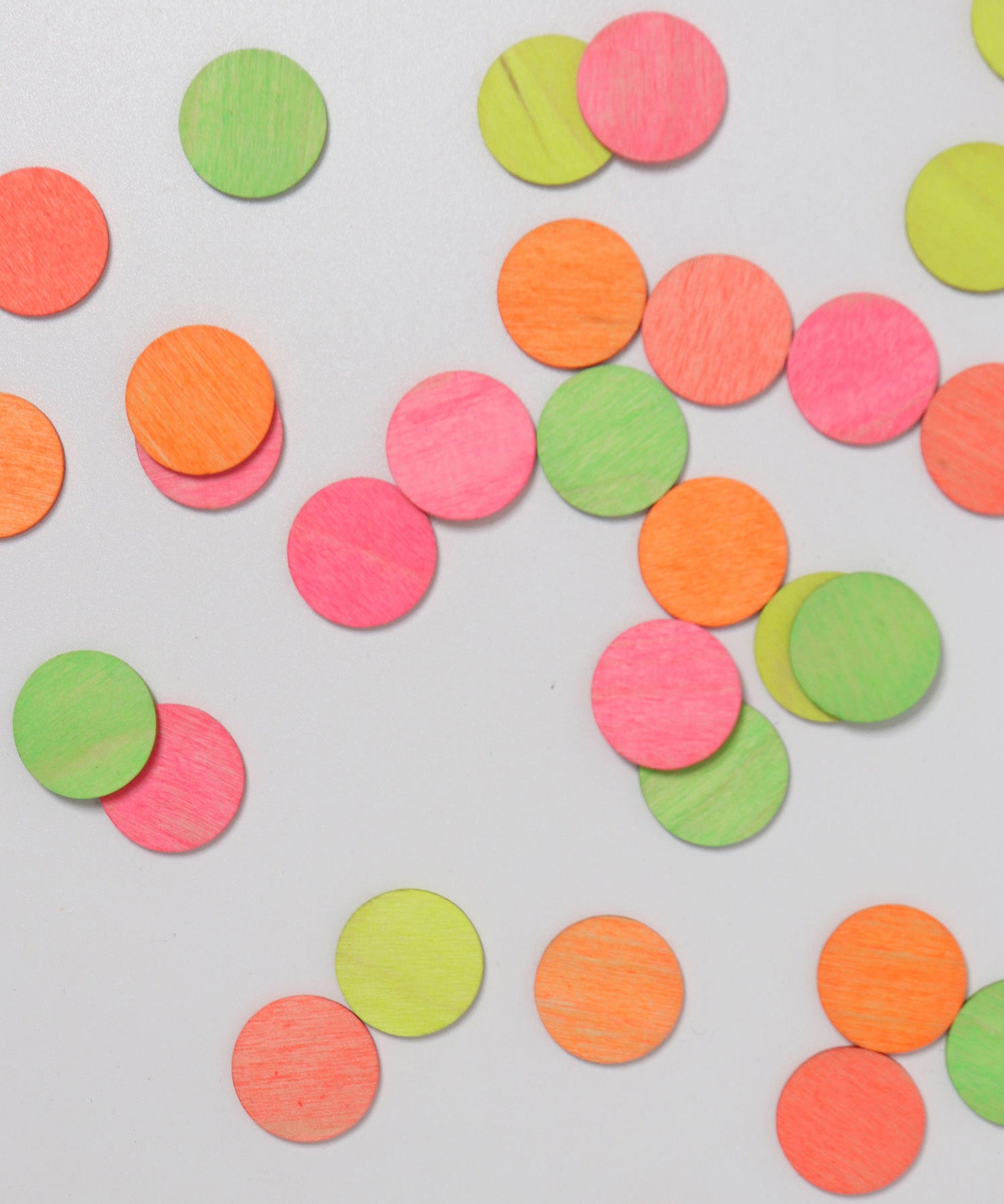 A top down view of the Grimm's Neon Celebration Confetti Dots scattered on a surface