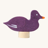Grimms wooden sitting purple duck decorative figure with a hand painted finish. Features a small base stand on the bottom to slot in a celebration ring