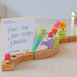 Grimm's Sweet Cone wooden Decorative Figure - Neon Green. The cone sits inside the Celebration ring alongside other Grimm's figures.