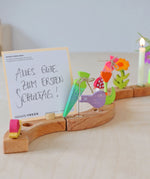 Grimm's Sweet Cone wooden Decorative Figure - Neon Green. The cone sits inside the Celebration ring alongside other Grimm's figures.