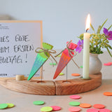 Grimm's Sweet Cone wooden Decorative Figure - Neon Green. The cone sits inside the Celebration ring alongside the Neon Pink Cone and a candle.