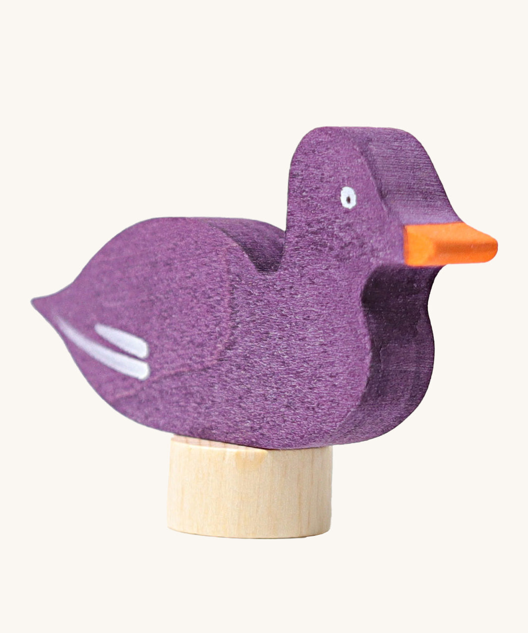 A close up of the Grimms wooden sitting purple duck decorative figure showing the hand painted finish and thickness of the figure