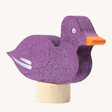 A close up of the Grimms wooden sitting purple duck decorative figure showing the hand painted finish and thickness of the figure