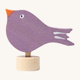 Grimms wooden purple singing bird with hand painted facial features standing on  a small base stand to slot in the celebration ring or stand