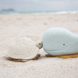 Hevea vanilla turtle and blue whale bath toys on the beach