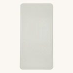 Hevea natural rubber bath mat in the marble grey on a beige background