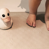 Close up of child's feet and rubber duck on a Hevea rubber bath mat