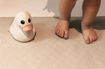 Close up of child's feet and rubber duck on a Hevea rubber bath mat