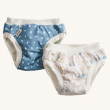A pack of two Imse Vimse Blue and Teddy design reusable Training Pants for toddlers weighing from 16-20 kg available at Babipur. Two comfortable Cotton reusable training pants. The one on the left is blue with white scribbled sports, and the one on the right is white with colourful rabbits, bears, dogs, rainbows, clouds.