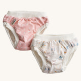 A pack of two Imse Vimse Pink and Teddy design reusable Training Pants for toddlers weighing from 16-20 kg available at Babipur. Two comfortable Cotton reusable training pants. The one on the left is pink with white scribbled sports, and the one on the right is white with colourful rabbits, bears, dogs, rainbows, clouds.