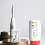 Jack N' Jill Fluoride-Free Strawberry Toothpaste 200g pictured next to buzzy brush toothbrush.